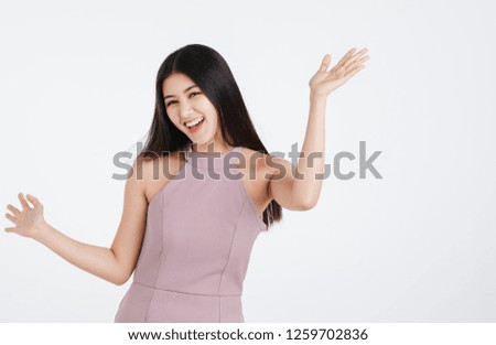 Beautiful young asian woman in pink dress, feeling very happy enjoy dancing, portrait short isolated on white background.
