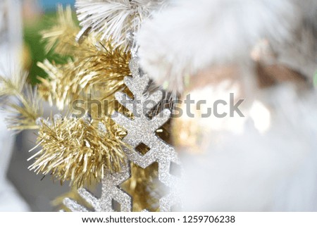 Merry christmas and happy new year Closeup of Christmas-tree  and gold balls,white balls, tree branches on abstract background