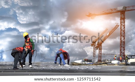 construction workers to roofing metal sheet in construction site Royalty-Free Stock Photo #1259711542