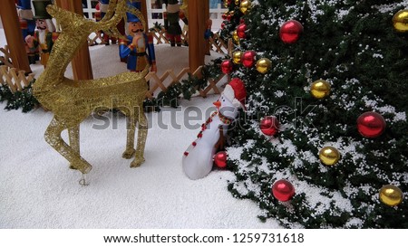 Christmas celebration decorations seen with snowman or dolls,golden deer, Christmas tree with colorful balls Low light photography with selective focus on subject 2 santa claus chennai india tamil nad