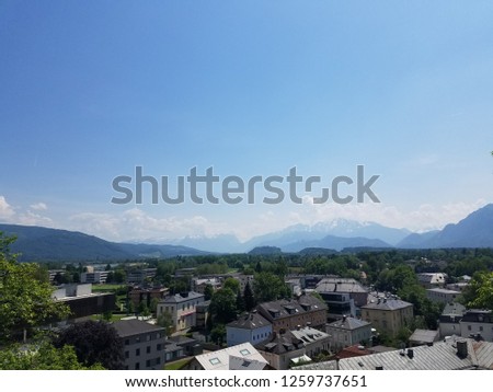 View of the city of Salzburg, Austria, from Hohensalzburg Fortress with the alps in the background with clear skies and vivid greenery