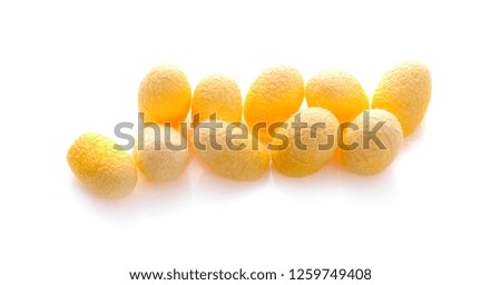 yellow thai silkworm cocoons pile isolated on white background