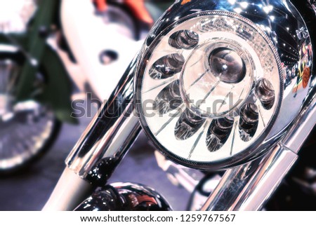 Headlight of classical vintage motorbike with shiny reflection and blurred background in vehicle design concept 