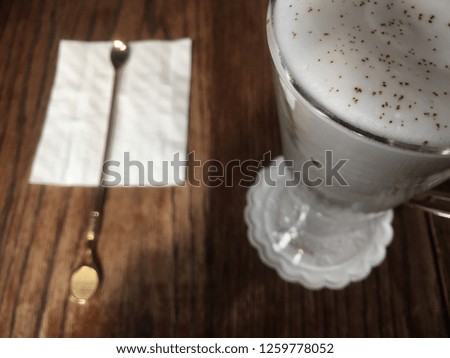 cappuccino and spoon on top wood table