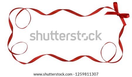 Twisted red satin ribbon in a frame with small bow isolated on white background