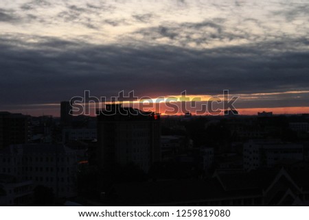 cloudy sunrise sky with city