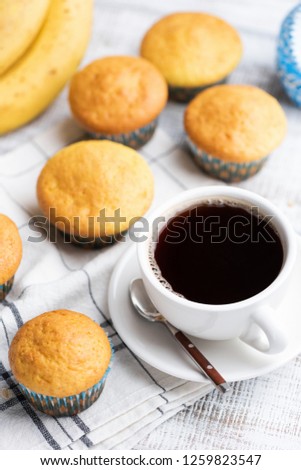 Muffins and cup of black coffee on table. Tasty breakfast, snack or lunch break