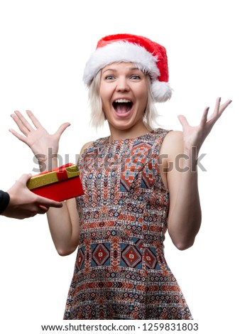 Picture of joyful woman in Santa's cap and man's hands with gift