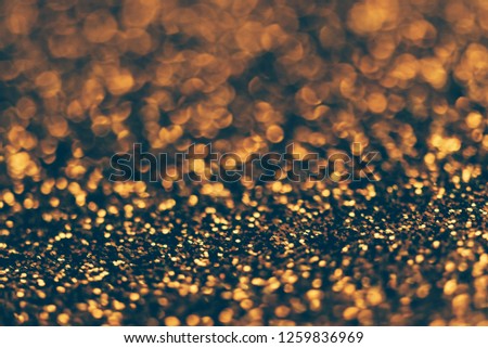 Blur neon gold light circle background. Sparkling firework bokeh dots in retro film filter style. Luxury and classy new year and christmas celebration textured backdrop. Blurry golden dust particles.