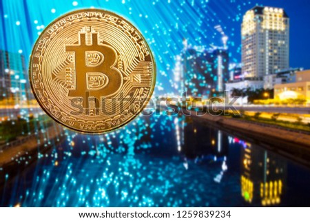 Golden bitcoin agains skyscrapers - futuristic smart city - cryptocurrency concept