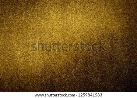 Shiny gold background is real metal, Yellow reflective surface for design for ribbon frame. A decorative theme for expressing luxury in text or greeting cards