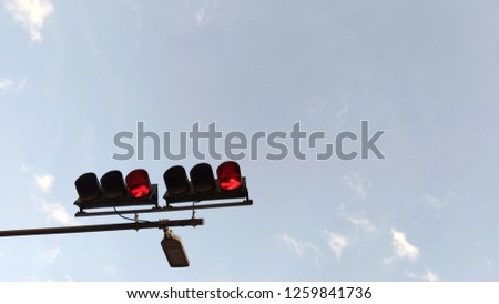 red arrow traffic light picture Red that says do not go straight to the front then do not turn right the background is the sky slightly cloudy