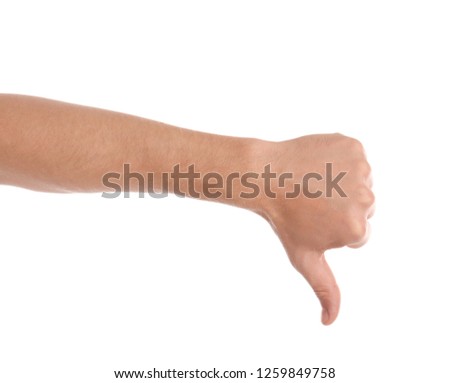 Man showing thumb down gesture on white background, closeup of hand