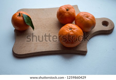 a ripe tangerines on a wooden deck