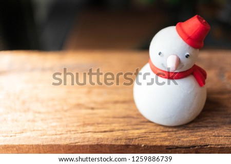 Snowman made from bread on the wood table with copy space