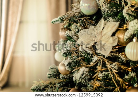 Beautiful gold and white decorations on a Cristmas tree