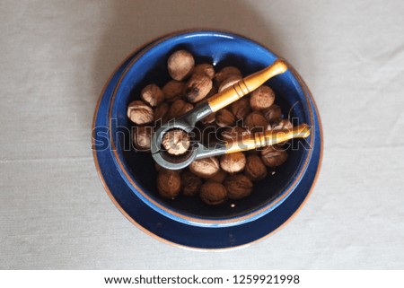 nutcracker with walnuts on a plate