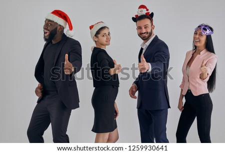 The four business people standing in red hats and gesturing