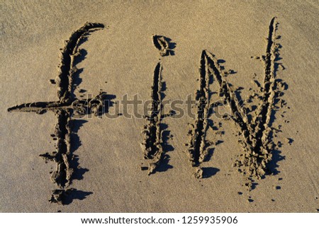The picture on the sand in the Crand Canaria beach.  The inscription "FIN"