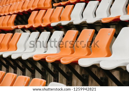 Orange empty stadium seats in arena 