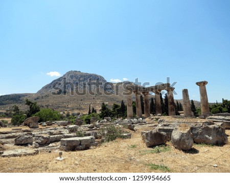   Europe, Greece, Corinth,remains of an ancient temple on the background of a mountain with a fortress
                             