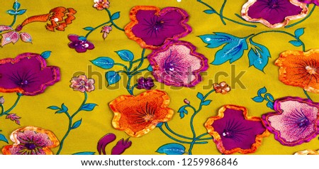 Silk fabric texture, background, green color, flowers, lace trimmed, blue red burgundy yellow, embroidered with glitter