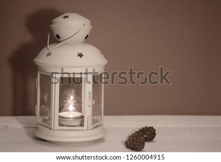 Christmas and New Year's background with candles, fir cones and beads on an old wooden table in rustic style, toned image.