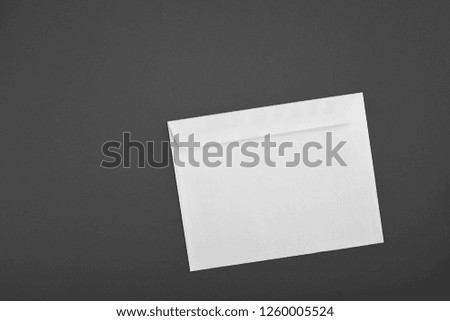 Photo of blank envelopes on a gray background. Template for branding identity. Envelopes mockup on changeable background. White paper isolated on gray. Top view.