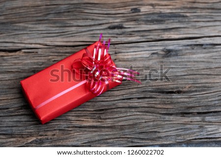 Red gift box on old wooden background