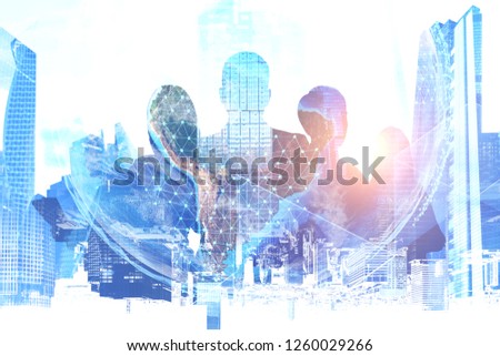 Silhouettes of business people over modern cityscape background with planet Earth hologram. Global business concept. Toned image double exposure Elements of this image furnished by NASA