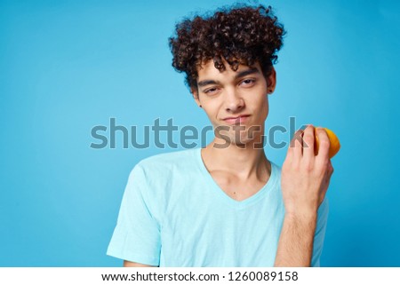 Curly handsome man on a blue background                   