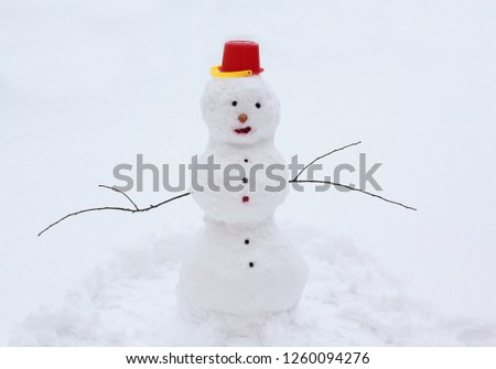 Happy snowman on snow, seasonal greetings, Christmas and New Year greetings, winter holiday celebration