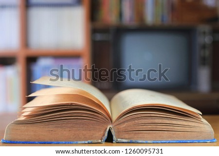 Close up of old books opened in the library bookshelf is the background selective focus and shallow depth of field