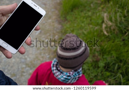 smart phone on the walk with the child