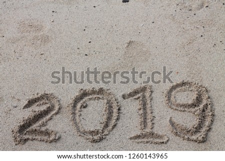 Happy new year 2019 or Christmas  on the sand use to background.