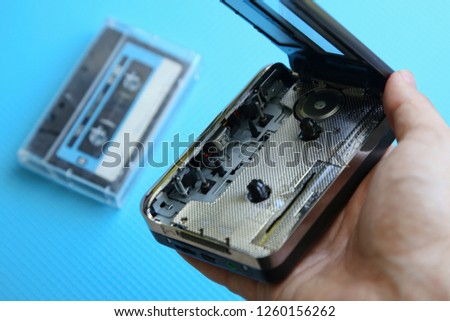 A tape cassette player on a blue background. Music playback concept image. 