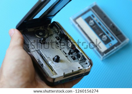 A tape cassette player on a blue background. Music playback concept image. 