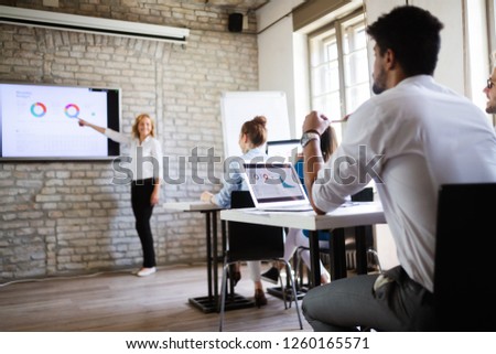 Successful happy group of people learning software engineering and business during presentation Royalty-Free Stock Photo #1260165571