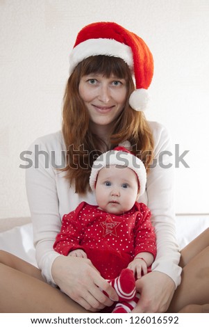 Mother and child smile and celebrate Christmas