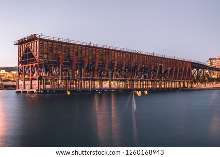 El Cable Ingles, also called Cargadero de Mineral, in Almeria: a structure that represents the iron architecture of the 20th century, at sunset. Royalty-Free Stock Photo #1260168943