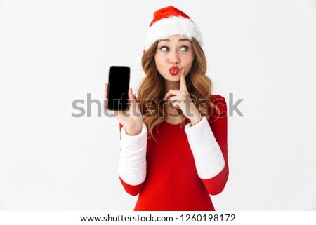 Picture of a beautiful emotional woman in christmas costume showing display of mobile phone.