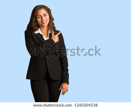 Full body young busines woman smiling and pointing to the side