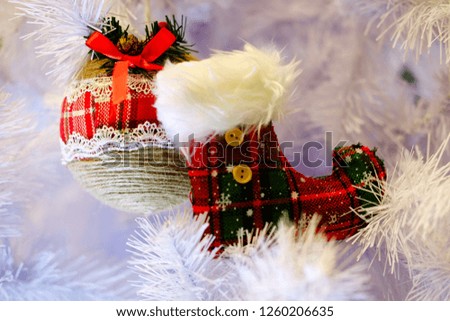 New Year's decorative red boot and round toy on a white background Christmas tree, the theme of the holidays and the new year
