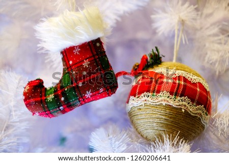 New Year's decorative red boot and round toy on a white background Christmas tree, the theme of the holidays and the new year
