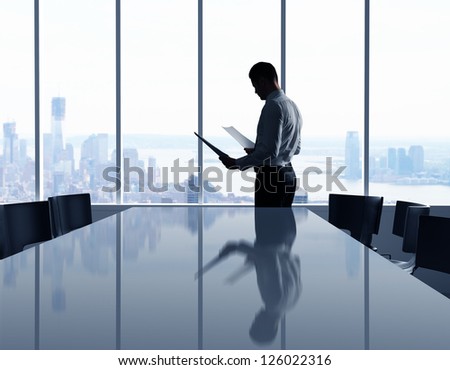 businessman in office and city in window