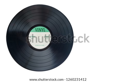 Closeup view of gramophone vinyl LP record or phonograph record with green label. Black musical long play album disc 12 inch 33 rpm spiral groove. Stereo sound record. Isolated on white background. Royalty-Free Stock Photo #1260231412