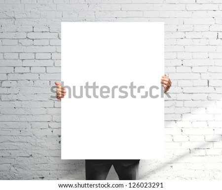 businessman holding white blank poster