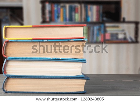 books on the table on the background of a bookshelf folded vertically