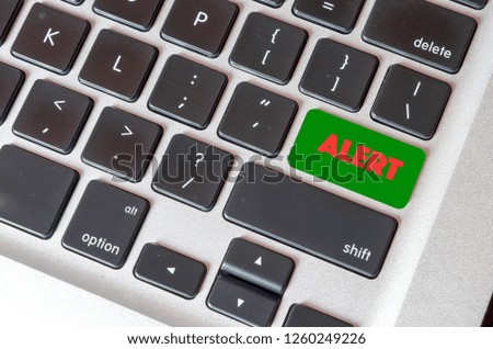 Conceptual image with text Alert on green keyboard button. - Image