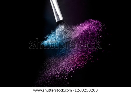 purple and blue ocean powder color splash and brush for makeup artist or graphic design in black background, look like a lively and joyful mood.